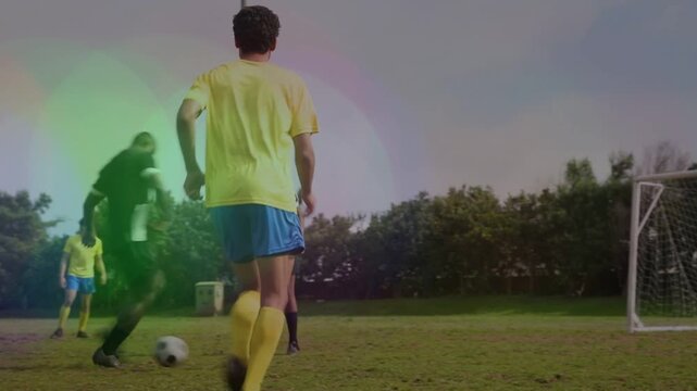 Soccer attacker advancing in box with ball, shooting to score, goalkeeper diving, team celebrating