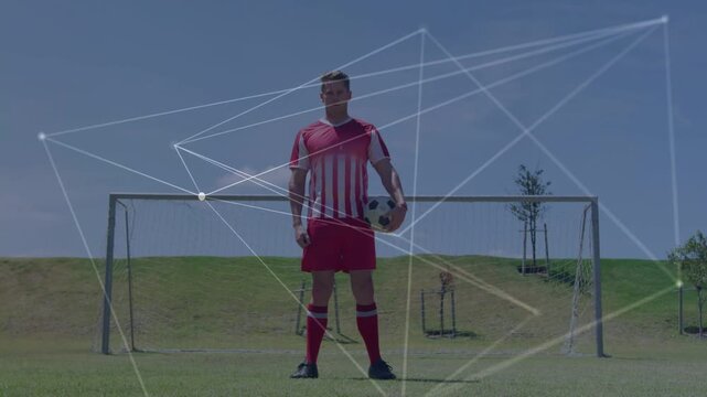 Soccer player holding ball in goal, play starting network sweeping over torso showing sports data