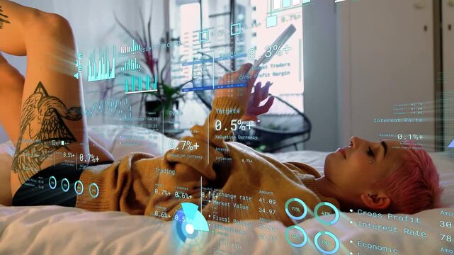 Woman reclining on bed shifting posture by tapping tablet and animating financial holograms