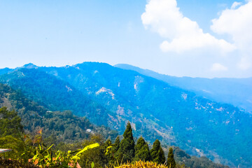 Fototapeta premium Panoramic view of Sittong, Darjeeling, West Bengal, India. Panoramic view of blue mountains peaks ridge.