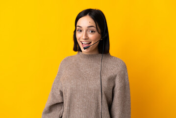 Fototapeta premium Young telemarketer woman isolated on yellow background with surprise facial expression