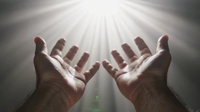 Hand reaching toward a radiant light, symbolizing hope, guidance, and the promise of a brighter future
