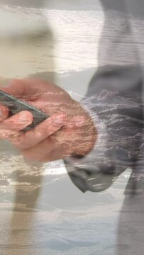 Vertical video: Thumb tap starting hands swiping phone, rotating, sea overlay growing as reflection