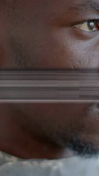 Vertical video: Man turning head and shifting gaze on play, glitch revealing smile in tech closeup