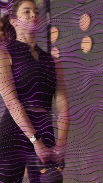 Vertical video: Woman swinging kettlebell, hips driving motion, purple overlay sweeping for fitness