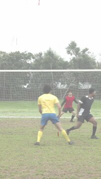 Vertical video: Attackers in box to score shot defender closing GK clearing sports HUD tracing ball