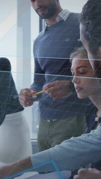 Vertical video: Project team pointing plans activating grid showing sections for business alignment