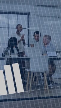 Vertical video: Data team at table, tapping laptop and showing binary panel over chart analyzing