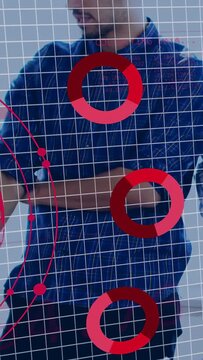 Vertical video: Man adjusting cuff as globe expanding, placing binary pie charts on torso for tech