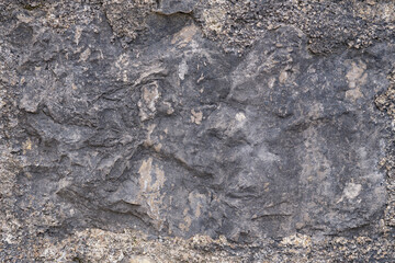 Fototapeta premium Dark rough texture of ancient stone wall, background. Copy space