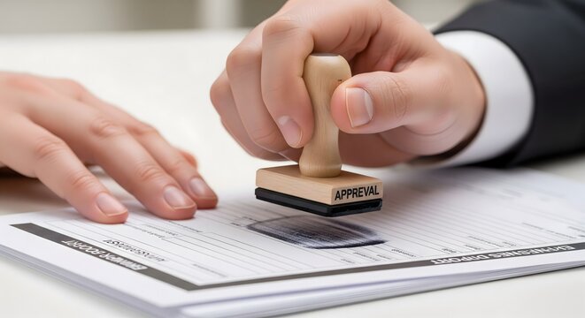 A professional's hand is seen stamping an official document with an 'Approved' mark, symbolizing successful validation and authorization.