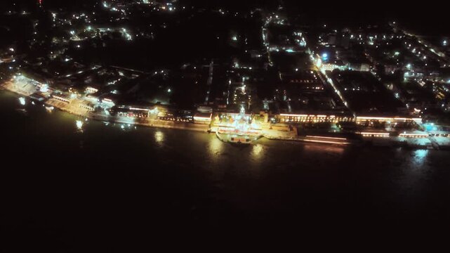 Peaceful night lights of Rishikesh reflecting on the Ganga river with a calm and spiritual ambiance.