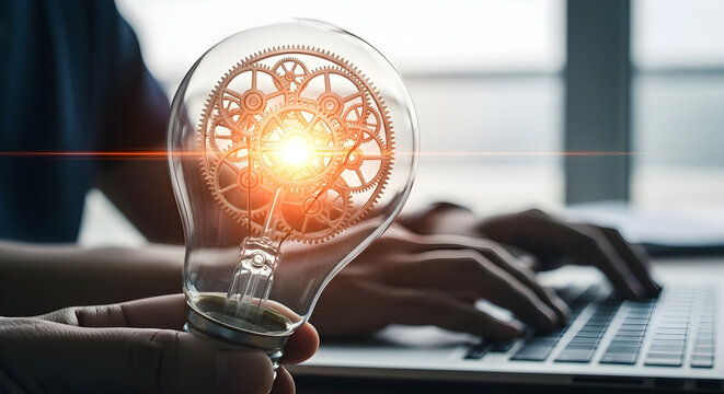 Innovative Business Concept of a Hand Holding a Light Bulb with Glowing Gears for Technology and Engineering Marketing.