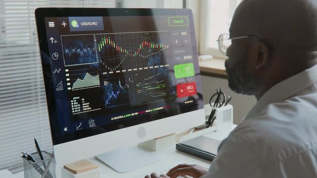 Man Working on Laptop Computer Trader and Investor Analyzing Financial News and Stock Market Index Updates on Tablets, Staying Informed on Global Market Trends and Movements