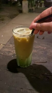 Macha coffe in glasss with hand 
