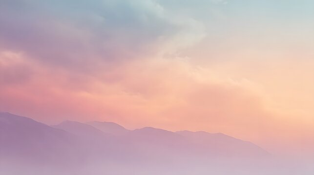 A breathtaking pastel gradient displaying layered distant mountains beneath a soft ethereal twilight sky