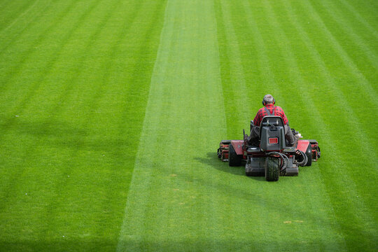 Mowing grass at the football stadium