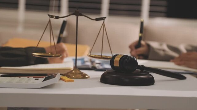 Consultation and conference of professional businesswoman and Male lawyers working and discussion having at law firm in office. Concepts of law, Judge gavel with scales of justice