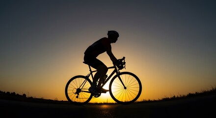 Fototapeta premium Silhouette of a person riding a bicycle against a beautiful sunset sky