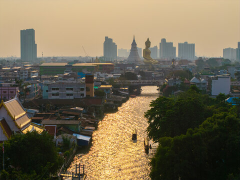 Aerial view Phra Buddha Dhammakaya Thep Mongkol Wat Paknam temple sunset light sky with modern office building