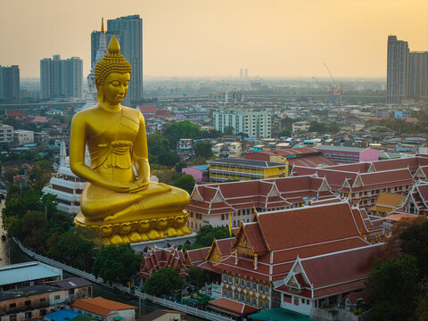 Aerial view Phra Buddha Dhammakaya Thep Mongkol Wat Paknam temple sunset light sky with modern office building