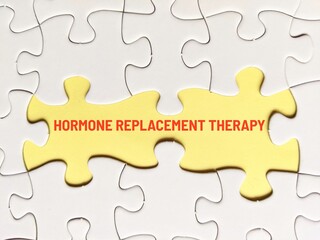 Fototapeta premium business concept puzzle. Jigsaw puzzle and yellow background with the word hormone replacement therapy