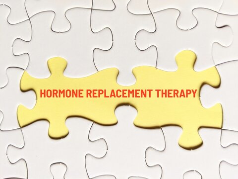 business concept puzzle. Jigsaw puzzle and yellow background with the word hormone replacement therapy