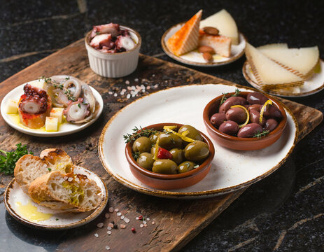 45-degree angle view of Spanish tapas variety presented in a vibrant flat lay arrangement.