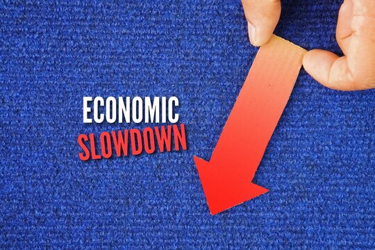 A red arrow down with the word economic downturn. decline in the rate of economic growth, characterized by reduced expansion in GDP, lower employment rates, and decreased business activity