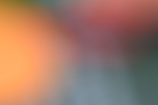 Abstract mix of warm and cool tones. hazy soft focus effect. orange blending into rose. muted blue shadows. smooth transitions. dreamlike atmospheric composition. gentle color bleeding