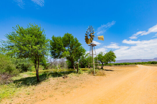 Windmill wind pump borehole in arid landscape