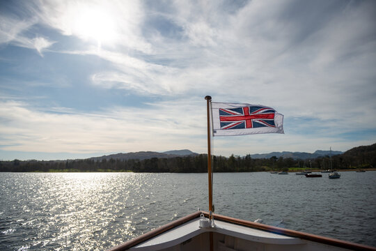 English flag, red cross on white on the Bow of a boat on a lake