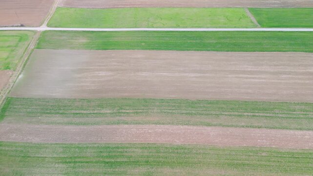 aerial farmland patchwork stripes top view for agriculture background with field patterns and cultivated land texture