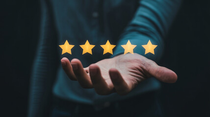 Hand holding five stars icon representing high quality rating customer experience or excellent feedback service evaluation.