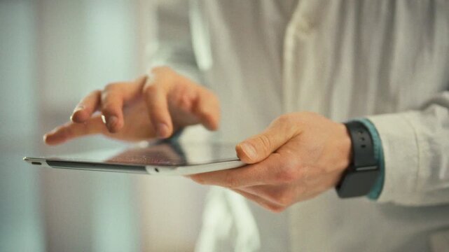 Doctor studies a panoramic x-ray on a digital tablet, pinching to zoom and scrutinizing damaged zones. This focused medical professional action supports accurate diagnosis and treatment in healthcare