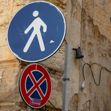 pedestrian an no-parking sign in a old town