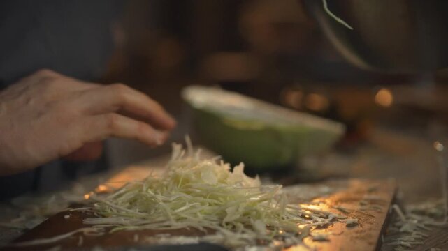 The skillful hands of a chef create a blend of fresh, sustainably grown cabbage, laying the foundation for a natural sauerkraut recipe that highlights the art of culinary preservation