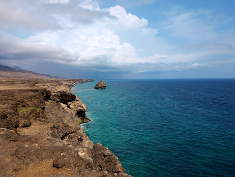 Ocean view from the Mirbat Cliff with the Crab island in the distance in Taqah, Oman. Scenic landscape