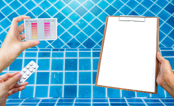 Water tester test kit with blank white paper over resort swimming pool background, quality water check, swimming pool maintenance and service