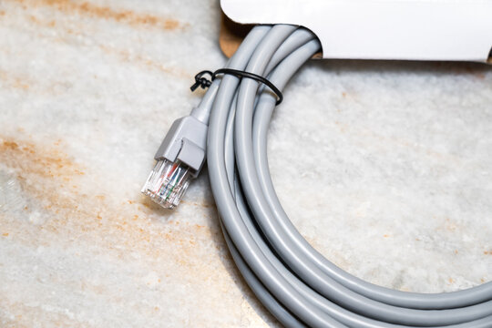 Cat-6 network cable on marble background. Ethernet cable.