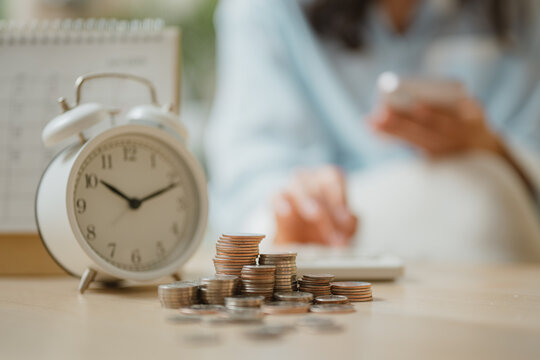 Bill payment reminder concept with alarm clock and coins representing due date alerts, recurring payments, and budgeting management, highlighting financial planning and timely expense tracking.