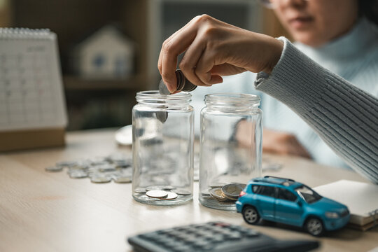 Person managing personal finances by saving coins into jars, representing budgeting, expense tracking, and financial planning for better money control, savings growth.