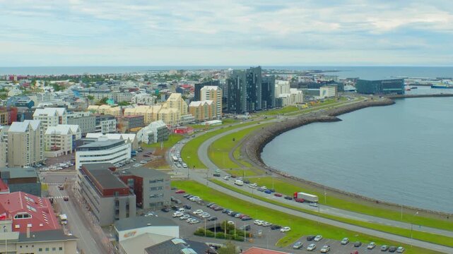 Reykjavik, Iceland. Aerial view of the city center of Reykjavik, Iceland during a cloudy day in summer. Time-lapse with car traffic in downtown, panning video