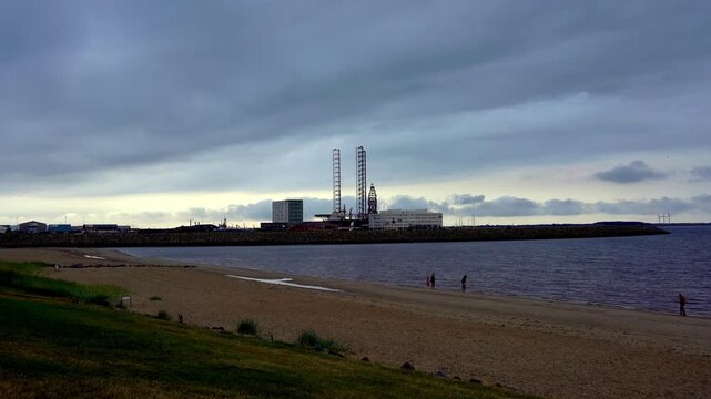 Sandy Beach with Industrial Harbor and Offshore Rig in Esbjerg, Denmark