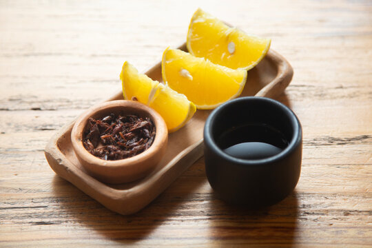 Chapulines and citrus slices served with Posh in Chiapas, Mexico.