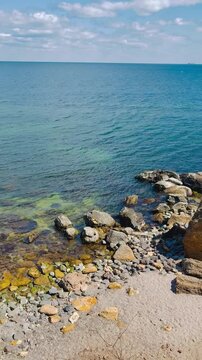 Rocky Sea Coast with Clear Turquoise Water and Horizon View