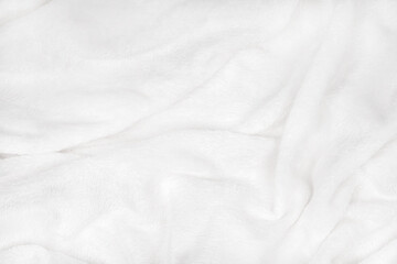 Obraz premium soft white blanket is spread out on a flat surface, its soft texture visible through it. It lies comfortably and feels warm.