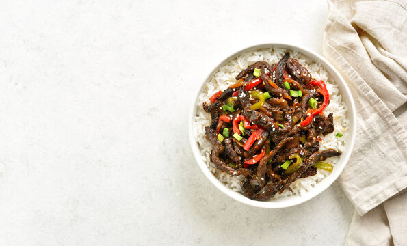 Crispy chilli beef in sweet and spicy chilli sauce with rice