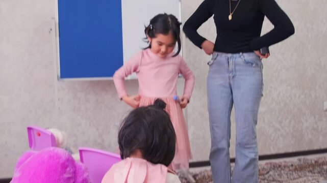 Young Asian girl acting as naughty student during home school role play with mother, refusing to listen, discipline problem, child behavior issue, parenting and education concept indoors