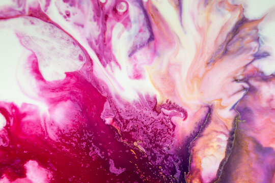 Colorful abstract art shows flowing patterns in various shades of pink and purple with hints of gold making unique shapes